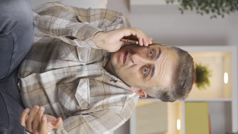 vertical video of the man who got bad news on the phone.