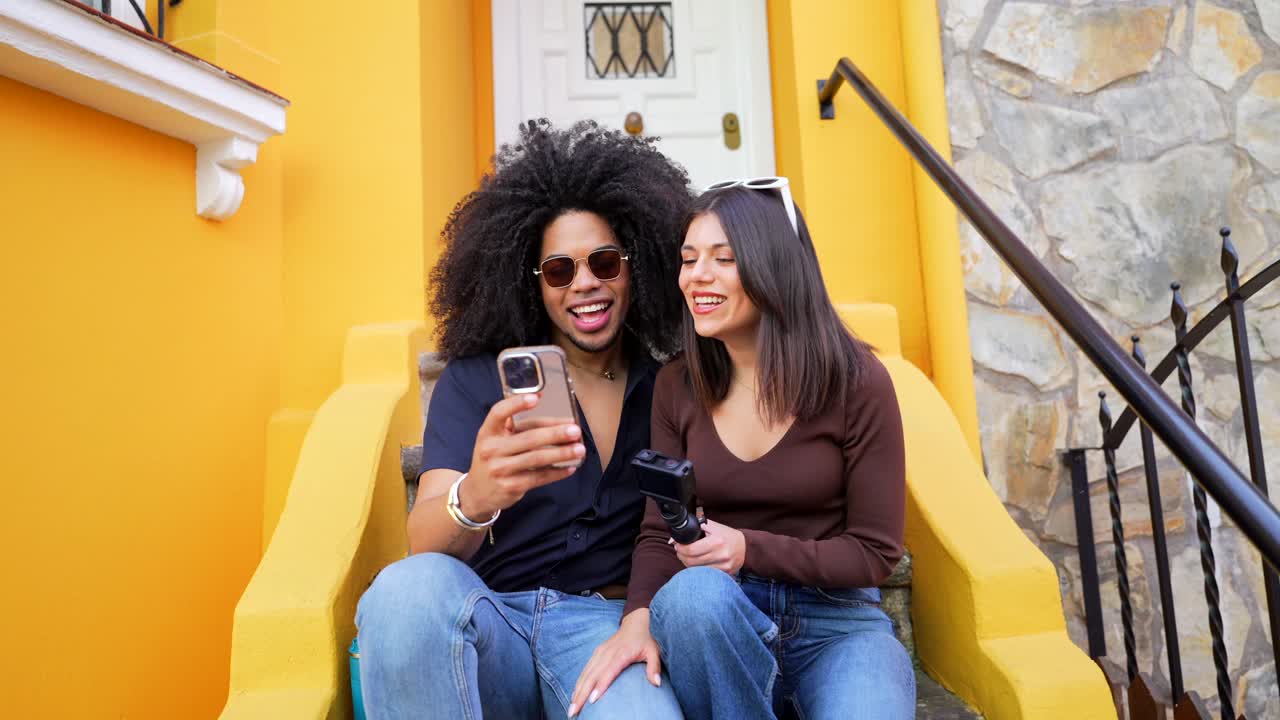 Couple sitting on stairs in front of house