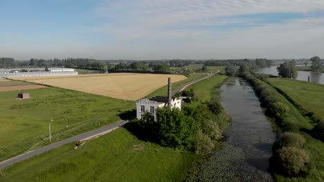 aerial view of ijsselstroom former industrial water management building revealing wider surrounding at the river ijssel riverbed and floodplains with greenhouses and de hoven neighbourhood in zutphen