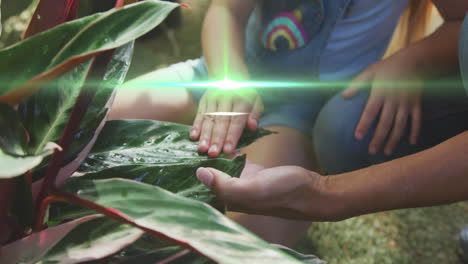 video of blue lights over biracial mother and daughter working in the garden