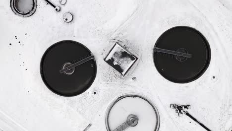 Top-down-view-of-water-treatment-systems-using-a-drone,-winter-landscapes