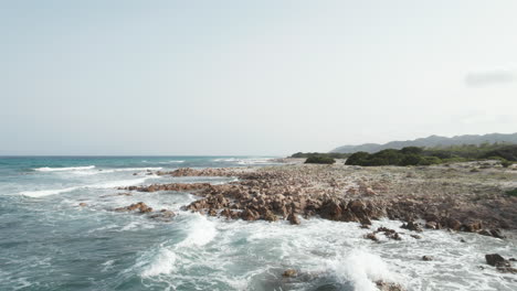 aerial view drone over beach sea and rock coast with powerful sea waves