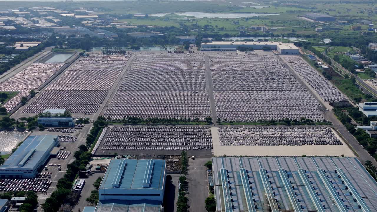 Massive inventory of unsold cars parked at an open warehouse beside Hyundai Motors India manufacturing plant in Chennai, Drone shot