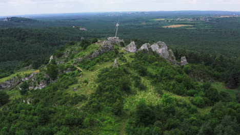 drone shot of góra zborów rocky hill surrounded by lush green forest nature reserve