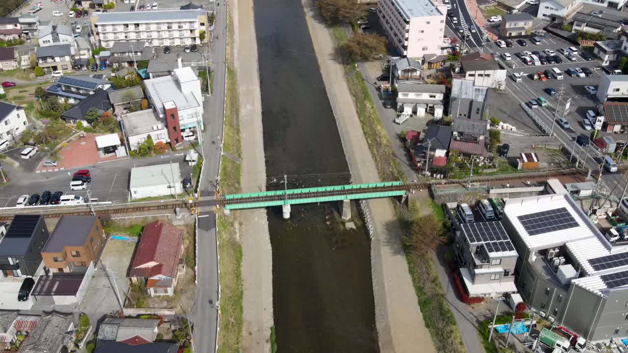 Aerial Birds Eye View Of Narai River With Tilt Up Reveal Of Matsumoto City. Dolly Forward