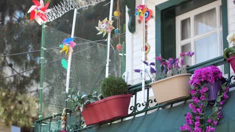 a colorful balcony with flowers, windmills and decorations