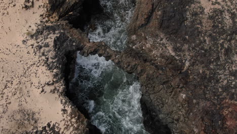 Spectacular-remote-aerial-shot-of-one-of-the-Caletones-arches-located-on-the-island-of-La-Graciosa