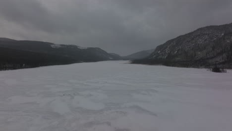 Low-Aerial-At-Frosted-Lake-During-Winter-In-Mont-du-Lac-a-L'Empeche,-Quebec,-Canada