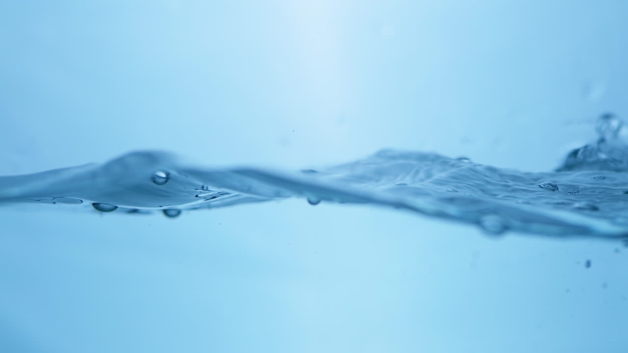 Serene imagery of water waves in slow motion, reflecting the beauty and cleanliness of natural drinking water.