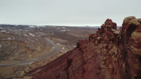 Rock-Formations-and-Cars-Driving-down-Road---Spotted-Wolf-Canyon,-Colorado---Aerial-Drone-Footage---Daytime