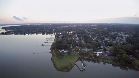 a drone flight taken in the early morning from portsmouth va, heading towards norfolk virginia showing suburban waterfront