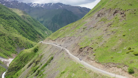 drone shot of a road in the caucasus mountains leading to juta georgia