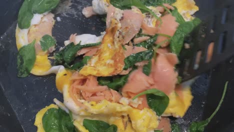 making scrambled eggs with spinach and salmon