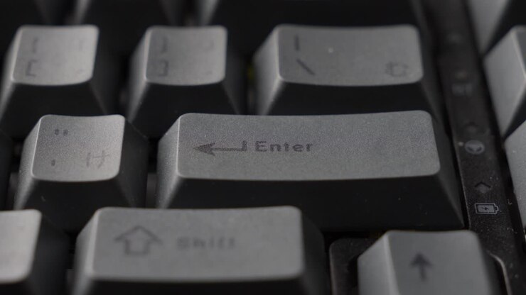 Finger Typing The Return Key Of Grey Mechanical Keyboard Of Computer, Close Up