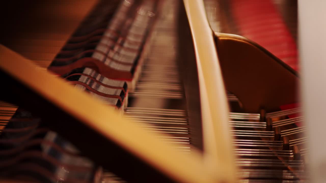 Handheld shot classic piano strings, hammers moving rhythmically, warm light, 4K