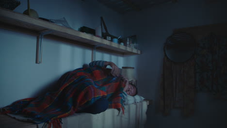 man sleeping in a dimly lit room