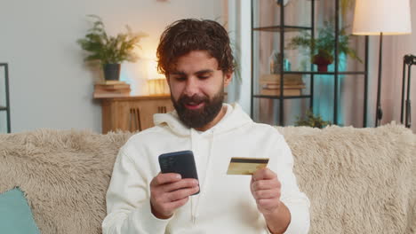 man making an online payment with his credit card.