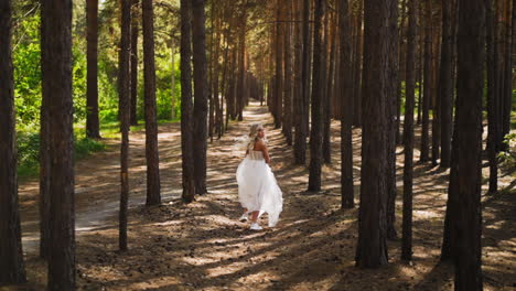 lady in wedding dress with chiffon skirt runs along forest