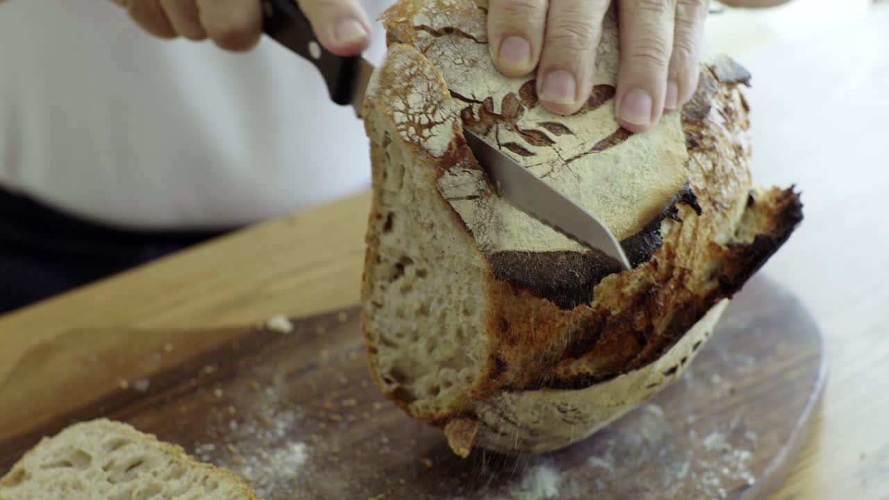 Cutting a loaf of fresh baked bread