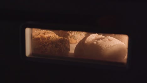 loaves of white bread and seed bread rising in the oven, timelapse