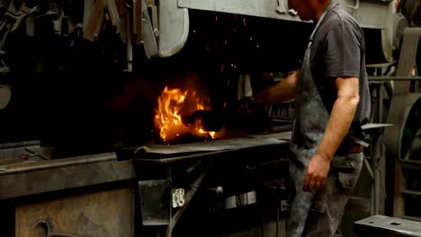 Blacksmith-putting-coal-in-fireplace-4k