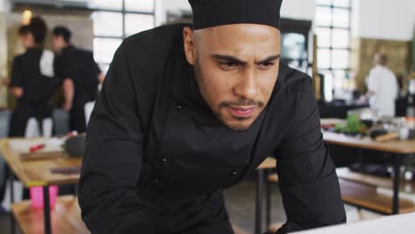 Mixed-race-male-chef-using-a-laptop