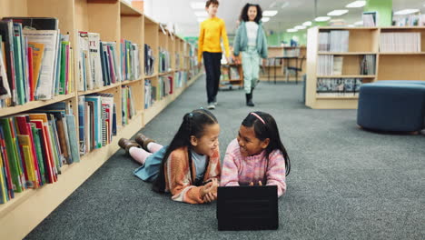children using a tablet in the library