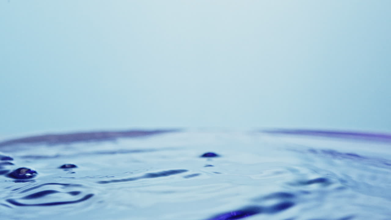 ice cube falling in a drink creating nice splashes