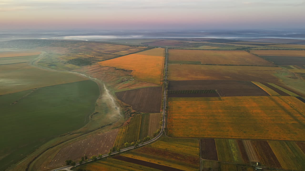 Aerial drone view of nature in Moldova at sunset. Fog and smoke in the air, wide fields
