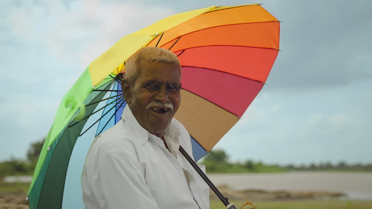 Elderly man with colorful umbrella