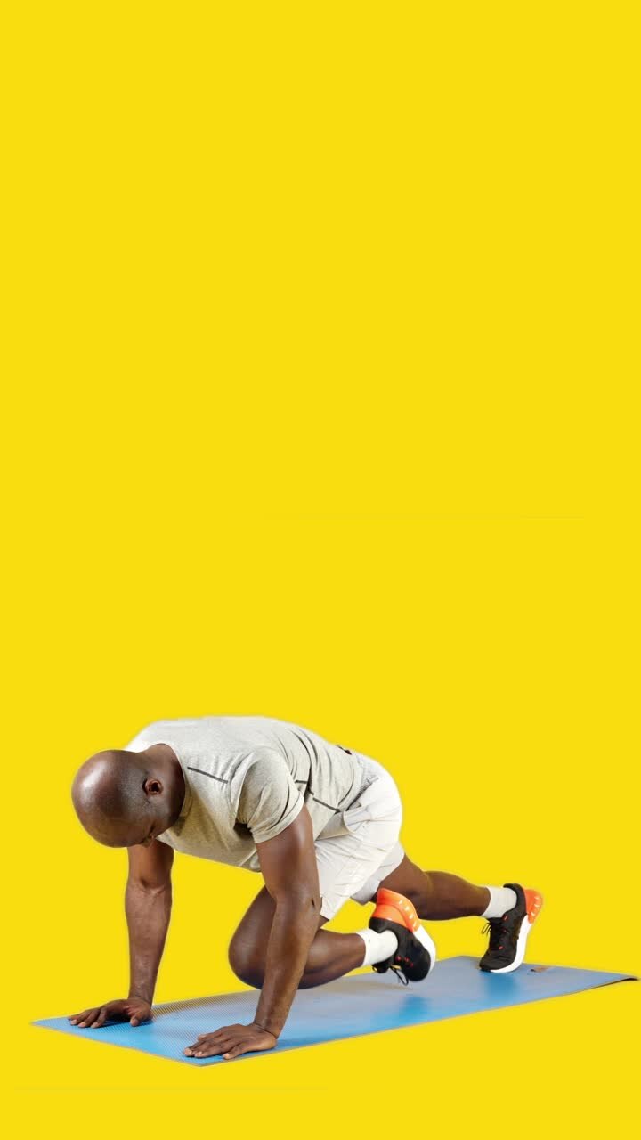 Man performing mountain climber exercise on a mat