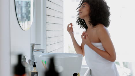 black woman, afro and hair care in bathroom mirror