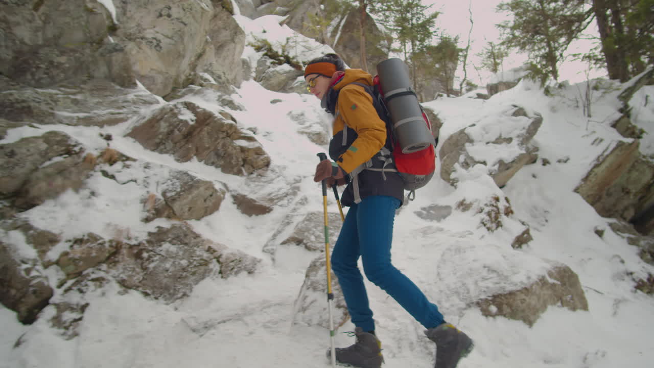 Woman Hiking on Steep Rocky Trail on Winter Day