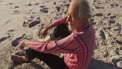 senior man sitting at the beach