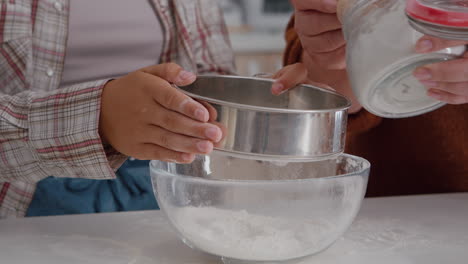 closeup of grandchild strain flour ingredient in kitchen bowl preparing homemade cookie dough