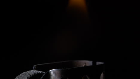 close up ignition of zippo lighter studio shot isolated on black background