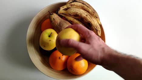 a big bowl of fruit is seen from above