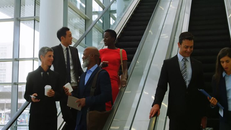 Business people talking on escalator 4k