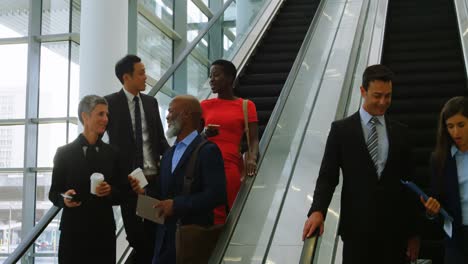 business people talking on escalator 4k