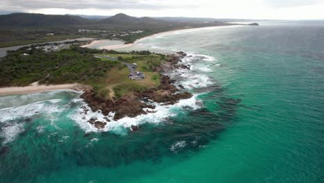 hastings point lookout and scenic seascape in hastings point, nsw, australia - aerial pullback