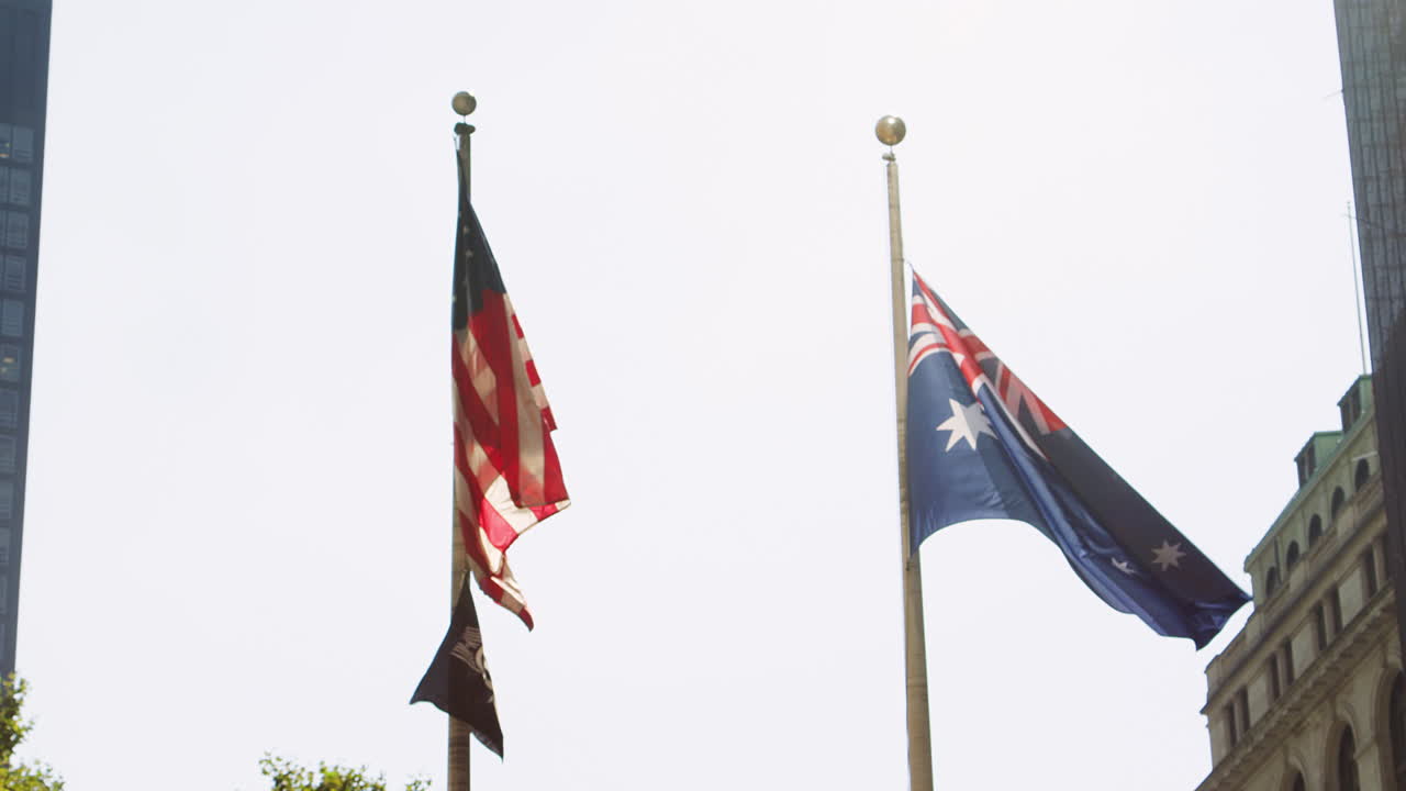 American And Australian Flags Flying From Flagpoles