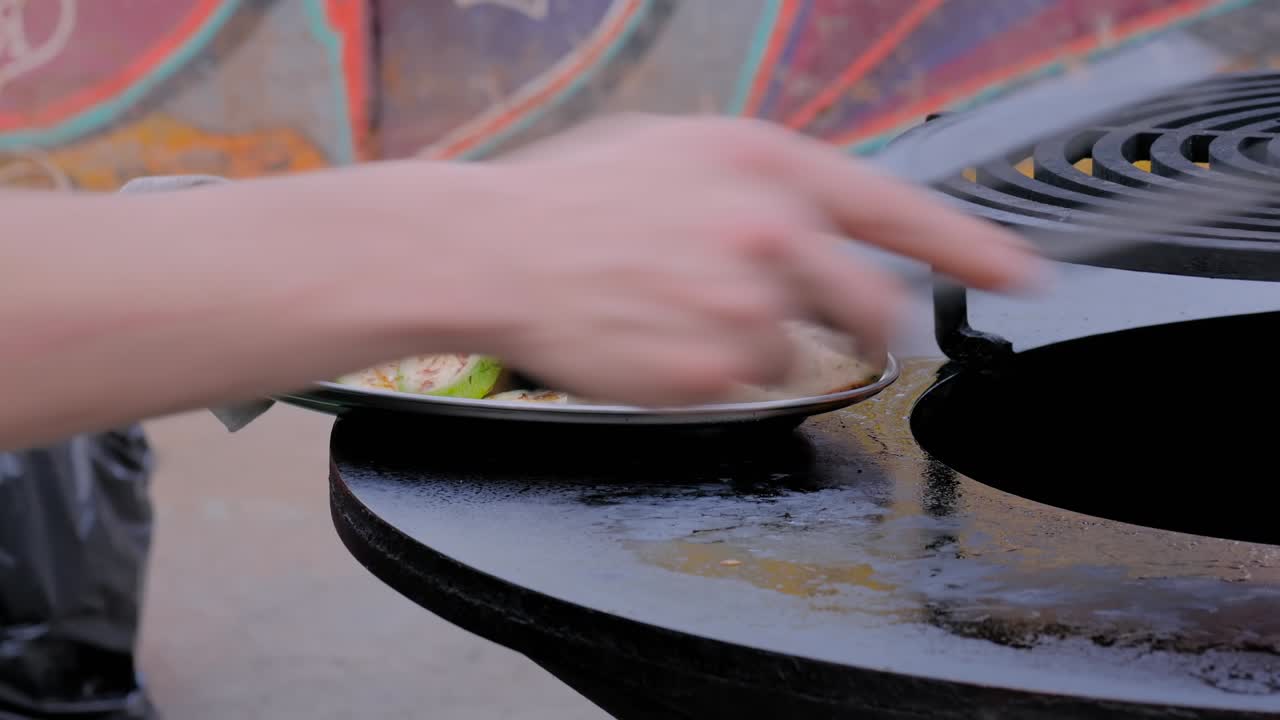 셰프 는 뜨거운 불 을 고 소시지 와 사키니 를 고 있다 - 근접