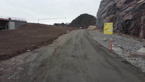 construction road with warning signs at klepland between mandal and kristiansand - construction of new highway e39 by companye nye veier as