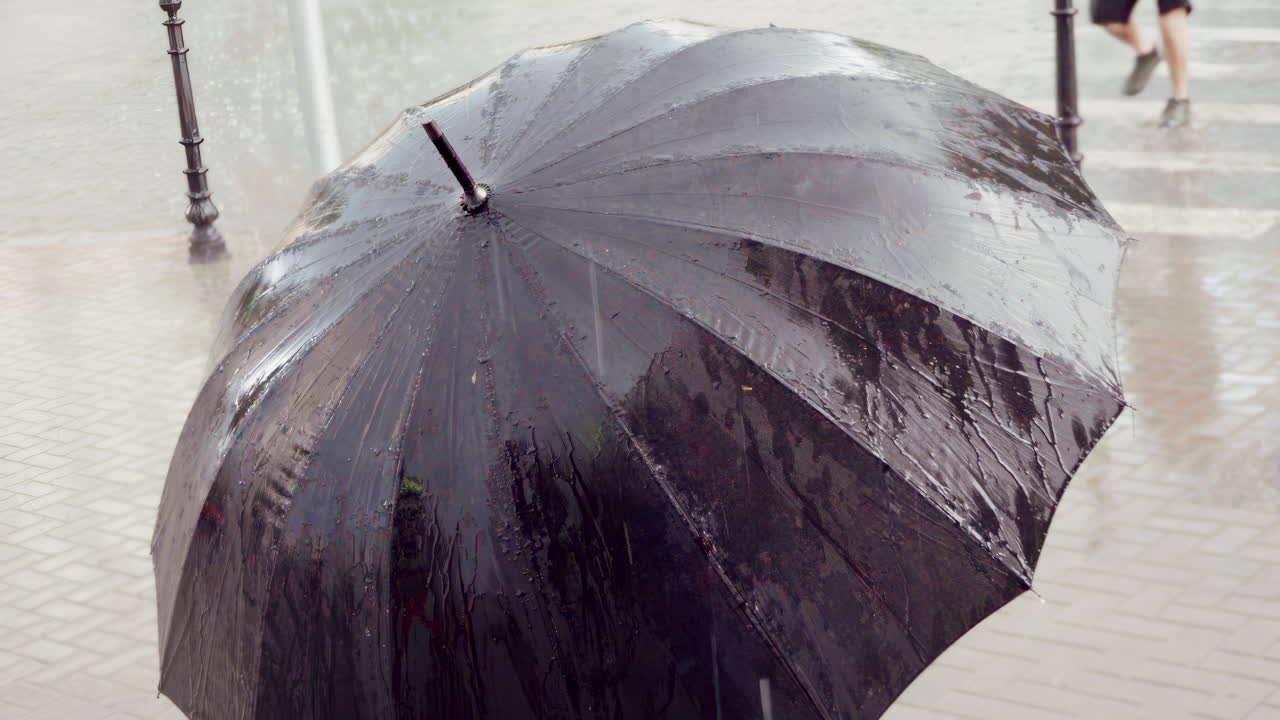 Close up of a black umbrella in the rain