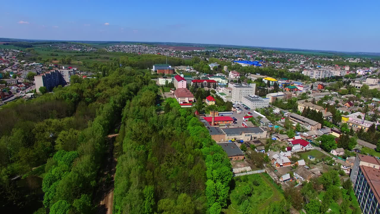 Sunny daytime footage over the beautiful Ukrainian city. Wonderful cityscape with lots of greenery. Top view.