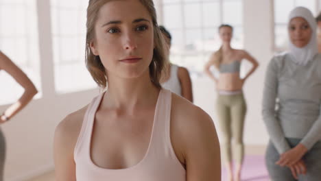 happy-yoga-woman-making-funny-hand-gestures-having-fun-in-fitness-studio