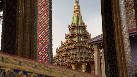 detailed stone pillars and ornate designs inside bangkok’s grand palace grounds