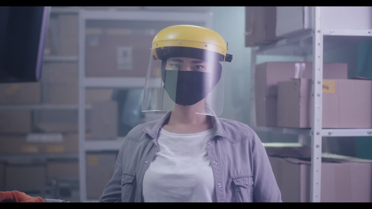 Woman in Warehouse with Safety Gear