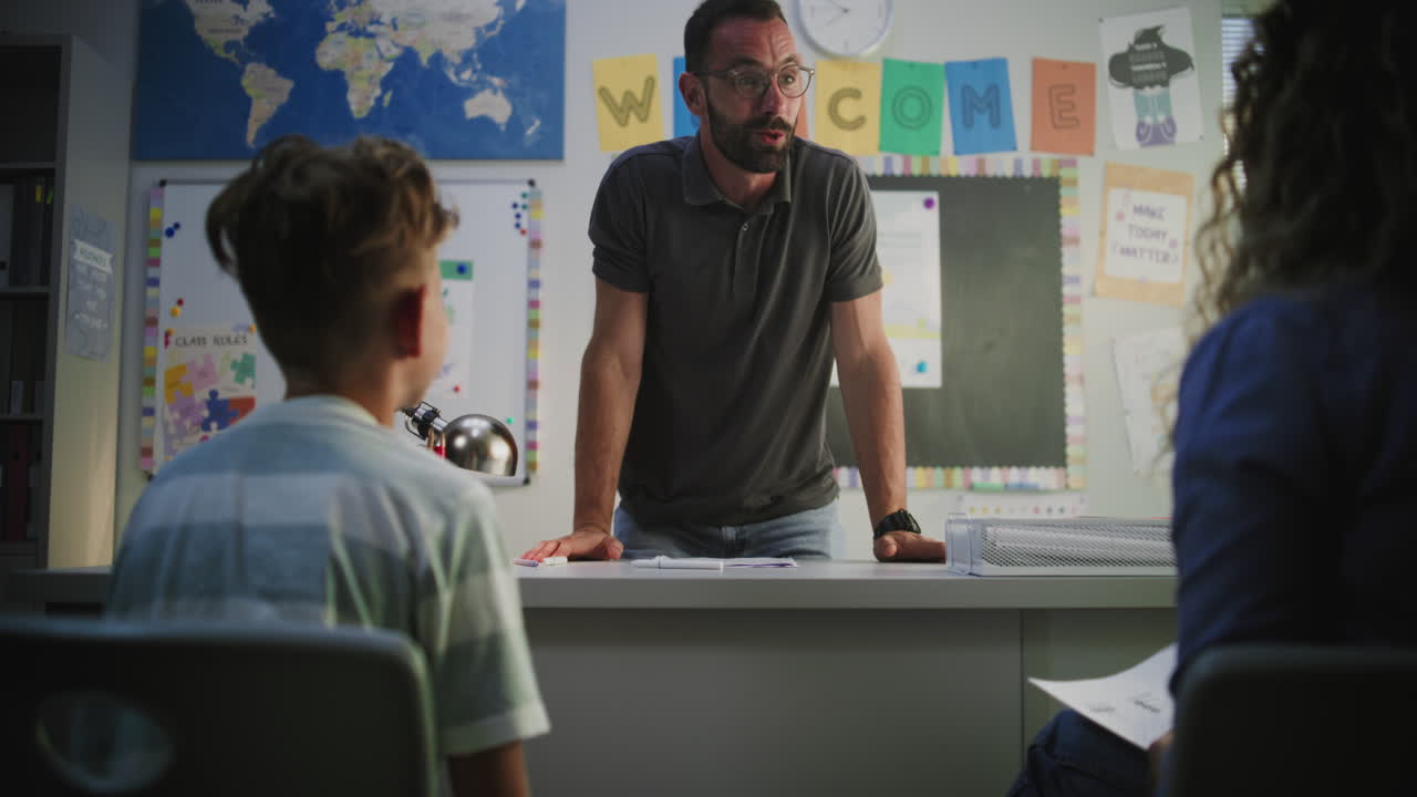 Teacher meeting with student and parent in classroom