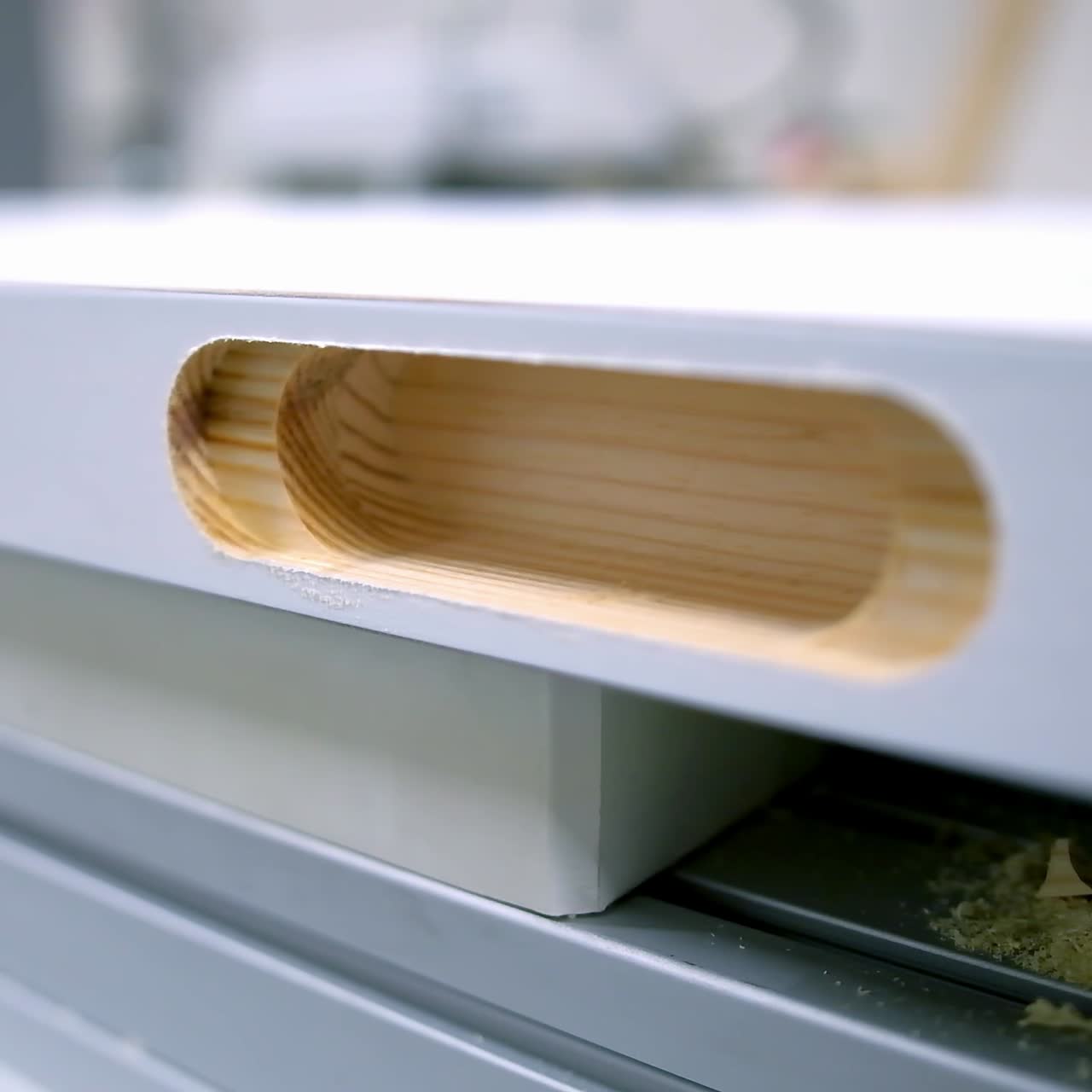 Wooden door in workshop. Manufacturing doors inside. Making furniture. Hole in wooden board. Production of doors. Close-up.